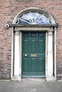 Vintage Georgian Green door with oval window over and columns at each side. Dublin, Ireland. Royalty Free Stock Photo