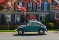 a vintage german motor car Volkswagen Beetle parked on a street. VW Beetle in Blue Die cast model.