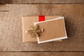 Vintage gift box package with blank gift tag on old wooden background. Christmas festive close up, copy space. Royalty Free Stock Photo