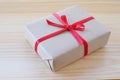 Vintage gift box with red ribbon bow on wood background Royalty Free Stock Photo