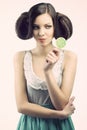 Vintage girl with lollipop, she looks the lollipop Royalty Free Stock Photo