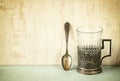 Vintage glass-holder over wooden table. retro filtered image
