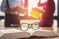 Vintage glasses,on books stack in public library book, Studying examining. Tutor books with friends. Young students campus