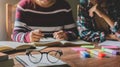 Vintage glasses on books stack in public library book, Studying examining Tutor books with friends. Young students campus helps