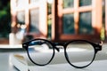 vintage glasses,on books stack in public library book, Studying examining. Tutor books with friends. Young students campus helps