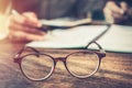 Vintage glasses,on wood table in public library book, Studying examining. Tutor books with friends. Young students campus helps