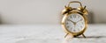 The vintage gold alarm clock on a marble surface in soft lighting AI generated image Royalty Free Stock Photo