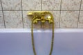 Vintage gold bathtub faucet and ceramic tiles in background.Retro bronze look. antique design Royalty Free Stock Photo