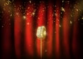 Vintage gold metal microphone. Red curtain background with spo Royalty Free Stock Photo