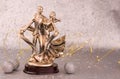 Vintage gold statuette of dancing young boy and girl on silver background