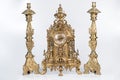 Vintage gold watch with candelabra on white background, bronze clock and candelabra, gold candlesticks and clock, antique clock an