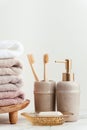 Vintage golden bath supplies with stack of clean soft towels next to soap and toothbrushes. White, pink and beige towels with Royalty Free Stock Photo