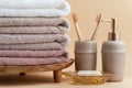 Vintage golden bath supplies with stack of clean soft towels next to soap and toothbrushes. White, pink and beige towels with Royalty Free Stock Photo