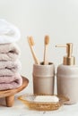 Vintage golden bath supplies with stack of clean soft towels next to soap and toothbrushes. White, pink and beige towels with Royalty Free Stock Photo