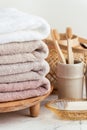 Vintage golden bath supplies with stack of clean soft towels next to soap and toothbrushes. White, pink and beige towels with Royalty Free Stock Photo