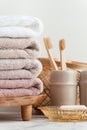 Vintage golden bath supplies with stack of clean soft towels next to soap and toothbrushes. White, pink and beige towels with Royalty Free Stock Photo