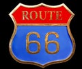 Vintage golden road sign interstate route 66 close up isolated on black background