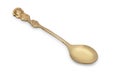 Vintage golden teaspoon with rich decorated handle in shape of rose and leaves floral ornament, isolated on a white background.