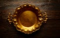 Vintage golden tray round on aged brown wood