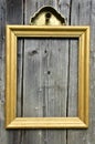 Vintage golden wooden picture frame on old wooden wall Royalty Free Stock Photo