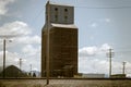 Vintage Grain Elevator Next to Railroad Tracks Royalty Free Stock Photo