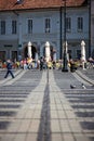 Coblestone pathway and old building facade with people passing by. Royalty Free Stock Photo