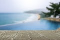 Vintage gray wooden tabletop on blurred pool and beach background