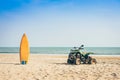 Vintage green ATV on the sandy beach. Quad ATV all terrain vehicle parked on beach, Motor bikes ready for action with summer sun Royalty Free Stock Photo