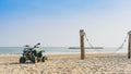 Vintage green ATV on the sandy beach. Quad ATV all terrain vehicle parked on beach, Motor bikes ready for action with summer sun Royalty Free Stock Photo