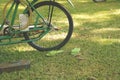Vintage Green Bike on Grass with Matching Plastic Shoes Royalty Free Stock Photo