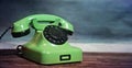 Vintage green cable telephone. Symbol of contact and landline telephony and communications