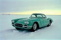 Vintage Green Car with White Dots in Snowy Field Royalty Free Stock Photo