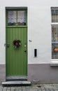 Vintage green front door decorated with Christmas wreath Royalty Free Stock Photo