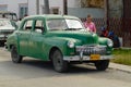 Vintage green Plymouth car parked at the street in Cojimar, Cuba.