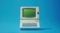 Vintage Green Screen Computer on Bright Blue Background Retro Computing Nostalgia Royalty Free Stock Photo