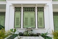 Vintage green wooden shutter window on white building, Thailand Royalty Free Stock Photo