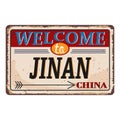 Vintage grunge Welcome to Jinan China rusted plate on white background