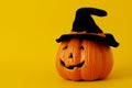 Vintage halloween pumpkin with hat black on yellow backgrounds