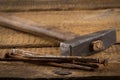 Vintage hammer with nails on wood background Royalty Free Stock Photo