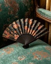 Vintage hand fan on antique chair Royalty Free Stock Photo