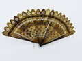 Vintage hand folding fan made of hand-decorated tortoiseshell sticks. Hand painted and decorated hand folding. Flowers drawings