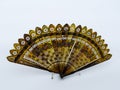 Vintage hand folding fan made of hand-decorated tortoiseshell sticks. Hand painted and decorated hand folding. Flowers drawings