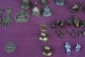 Vintage handmade bronze statuettes placed on the tablecloth