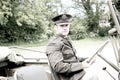 Handsome American WWII GI Army officer in uniform riding Willy Jeep