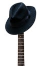 Vintage hat resting on a guitar fretboard