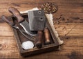 Vintage hatchets for meat in wooden box with salt and pepper on wooden table background with linen towel and fork and knife. Top