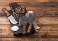 Vintage hatchets for meat on wooden chopping board with salt and pepper on wooden table background with linen towel and fork and