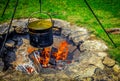 Pioneer family outdoor fire pit. Cauldron for boiling water. Royalty Free Stock Photo
