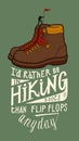 Vintage hiking boots with a tine hiking person on the top of them and a motivational lettering quote Royalty Free Stock Photo