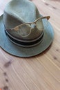 Vintage hipster concept with retro fedora hat, metal horn rimmed glasses perched on the front Royalty Free Stock Photo